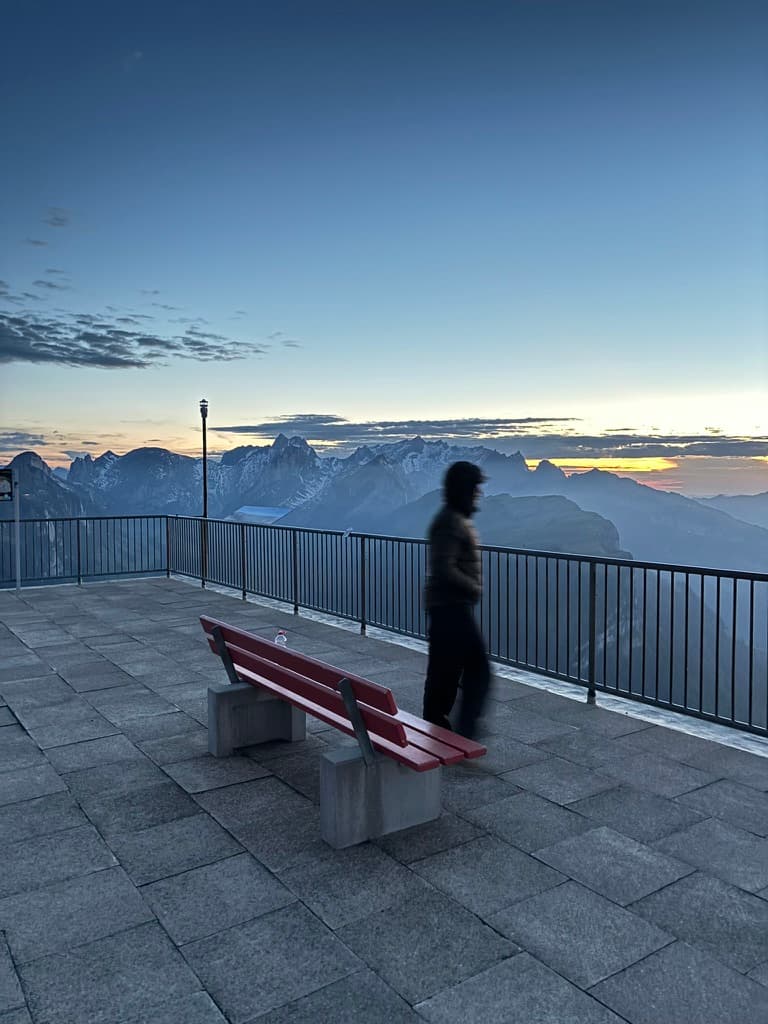 Corsin Curtins walking at an Alpstein viewpoint before sunrise